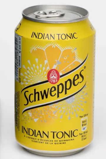 A yellow can of Schweppes Indian Tonic against a plain white background.